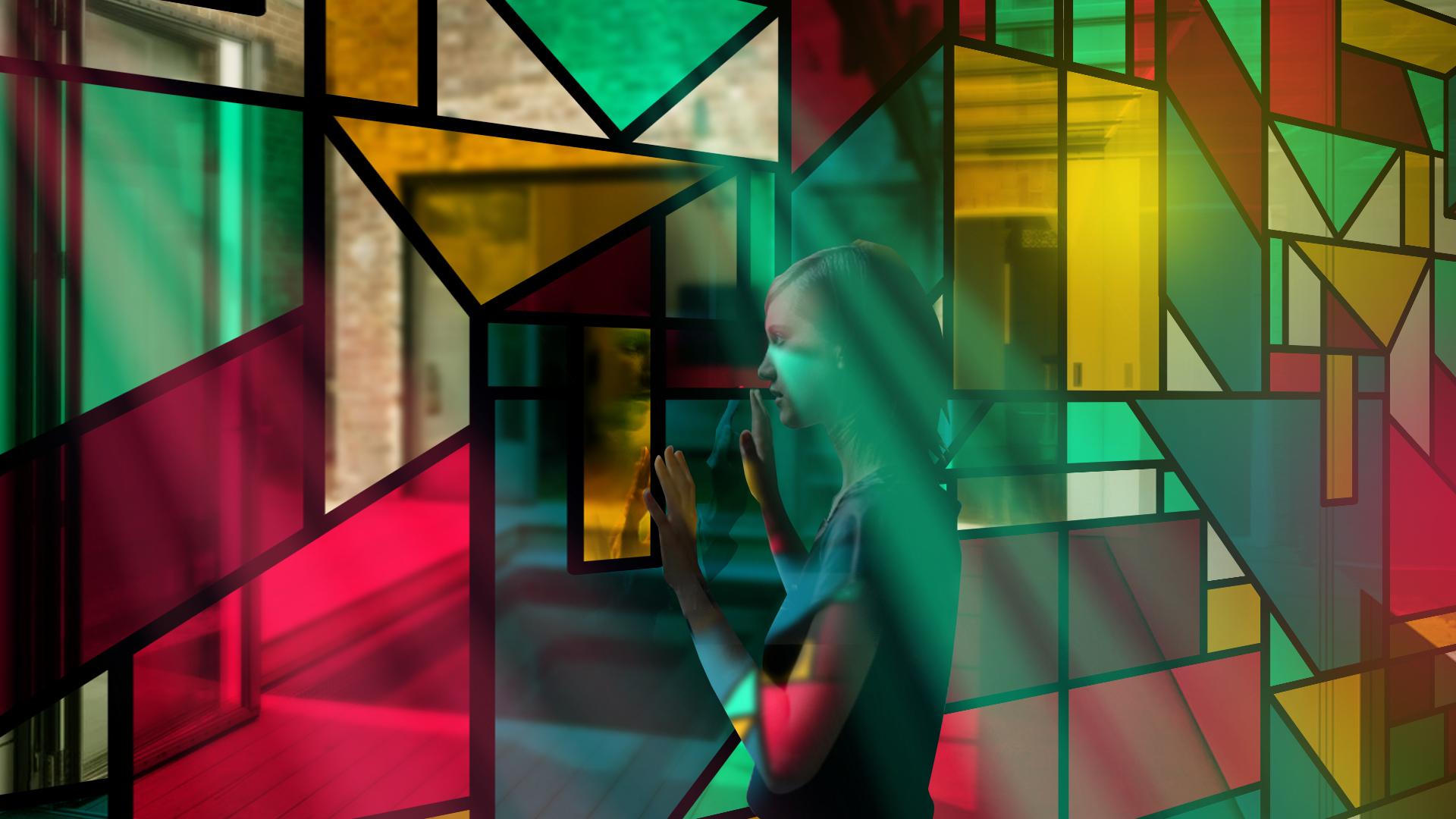 woman touching large transparent led screens with graphics simulating stained glass windows