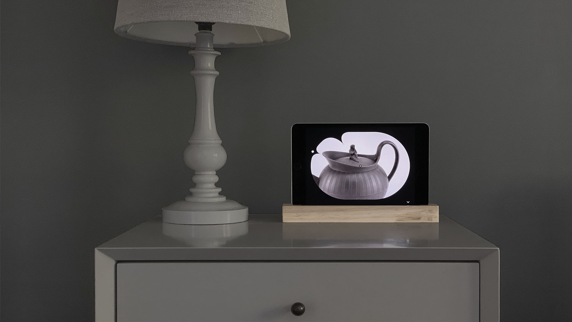 art clock displayed on a tablet resting on a table