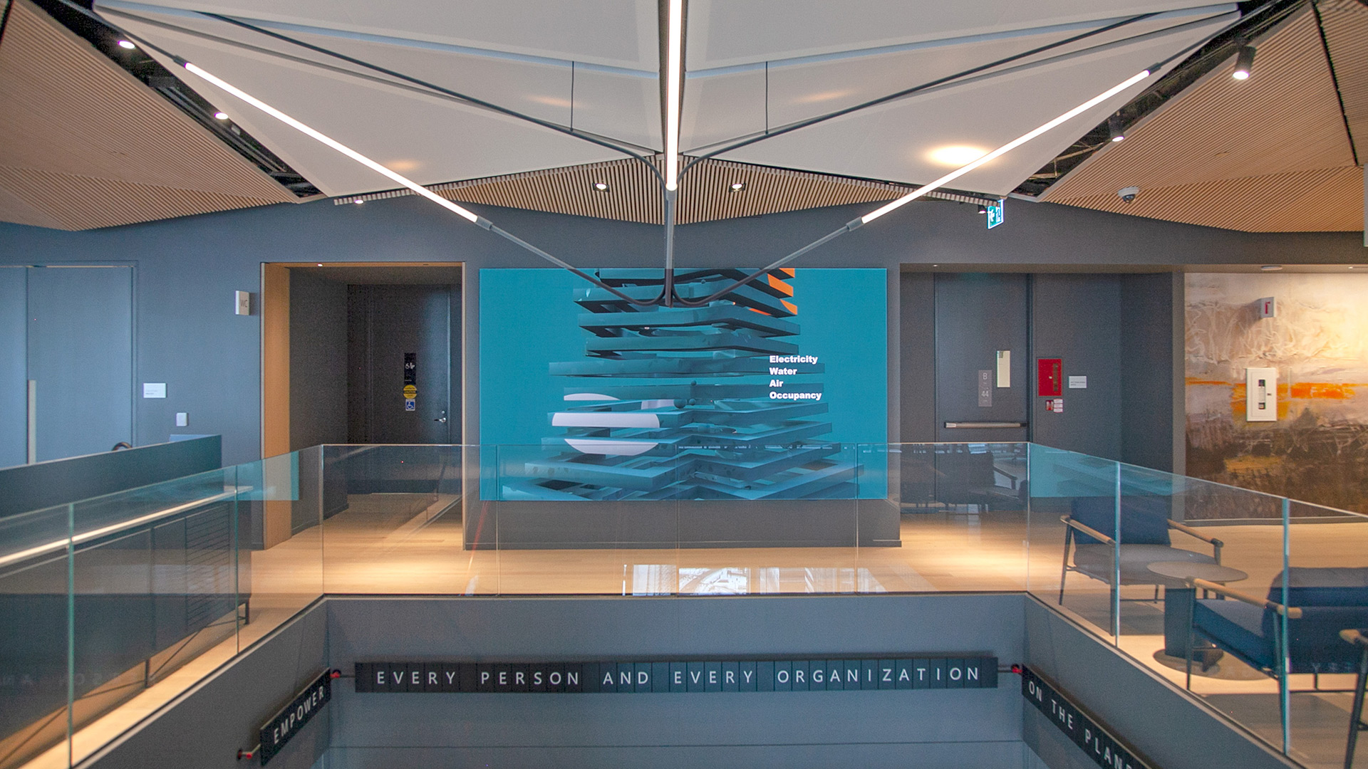 A large lobby display showing a the digital art sculpture called Day. The sculpture is formed based of live data measured within the building: Electricity, Water, Air and Occupancy