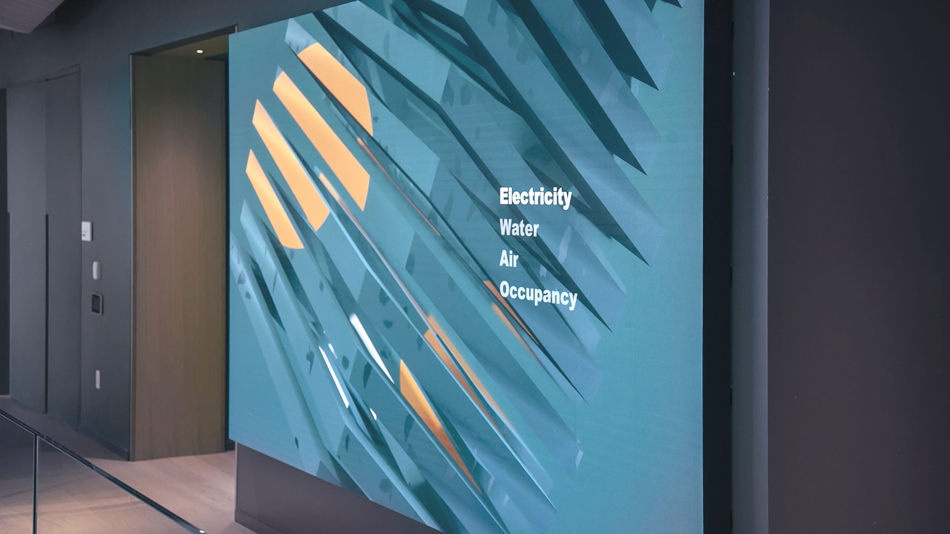 A side view of a large lobby display showing a the digital art sculpture called Day. The sculpture is formed based of live data measured within the building: Electricity, Water, Air and Occupancy.