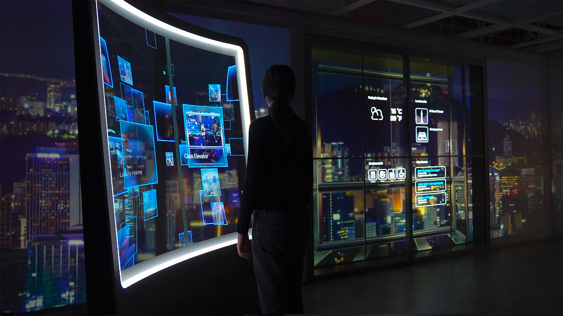 a dark room with a large interactive transparent oled screen. woman looking at projected cityscape