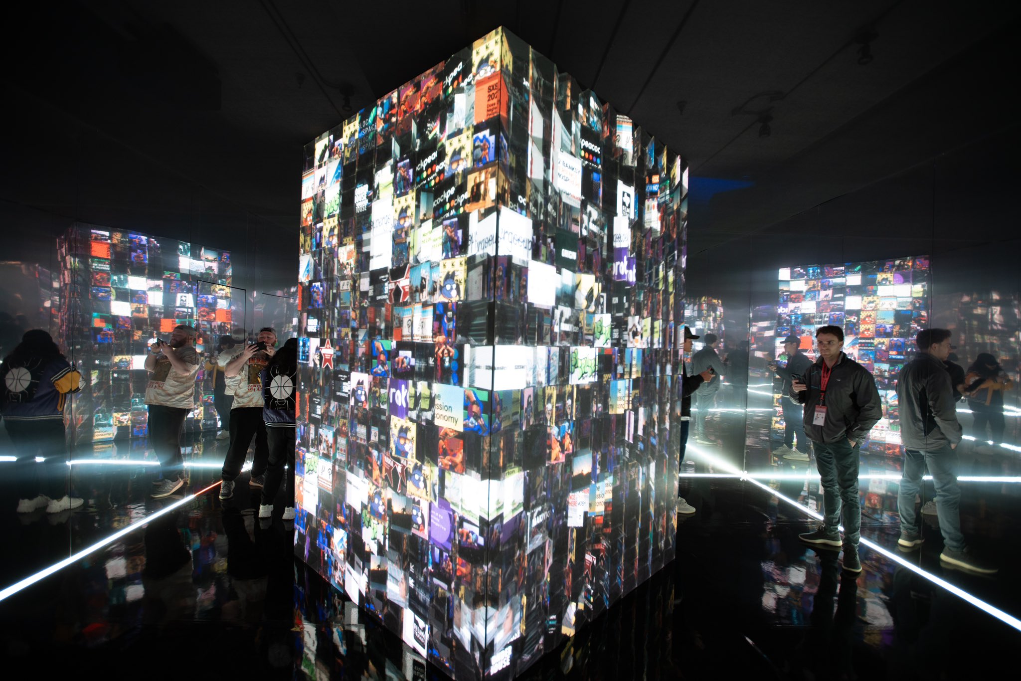 interactive art installation, dark infinity mirror room with persons silhouette